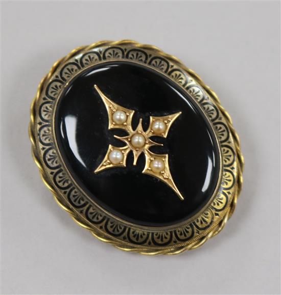 A Victorian yellow metal, black enamel and seed pear set oval mourning brooch, 44mm.